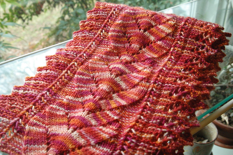 A multicolor red scarf knitted in a lace pattern