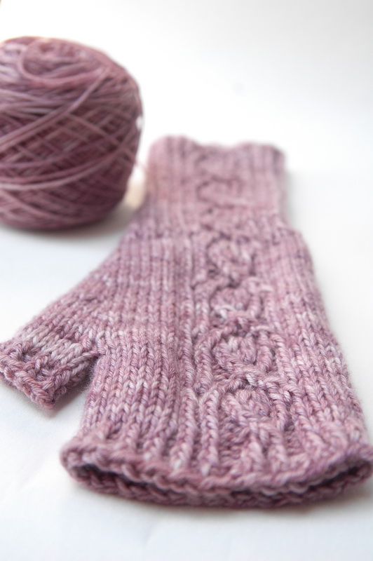 A pink hand knit fingerless mitt