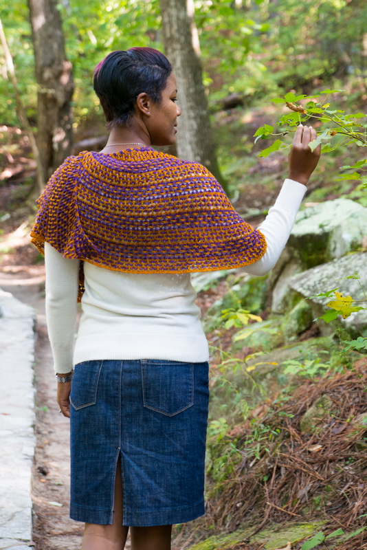 Love Child, lace combined with two colors and slipped stitches create this knitted shawl by Barbara Benson